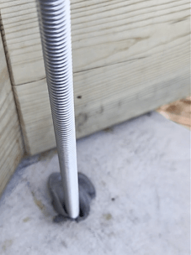 Half-inch steel threaded rods are installed 12 inches into the concrete piers.