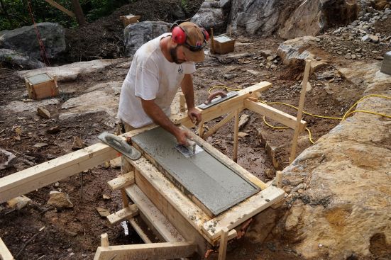 The crew places concrete and frames up stemwalls.