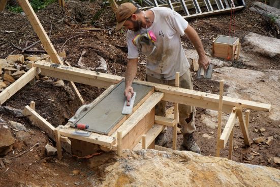 The crew places concrete and frames up stemwalls.