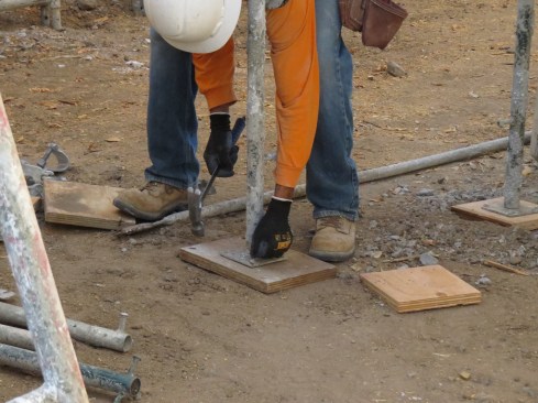 Base plates are mandatory on any scaffold, inside or outside. When set on soil, the base plate also should be securely attached to a mud sill, as shown here.