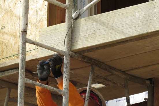 He wires the board in place.