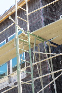 Outriggers are one way to extend the platform closer to a wall.