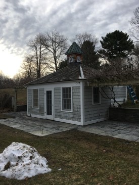 The original pool house. Piers have been poured for the new deck, and new bluestone pavers have been installed. The next step is to remove the cupola, which will be reinstalled later.