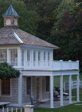 The railings and balusters were built out of clear red cedar. Note the deck's slight pitch, to allow the waterproof walking surface to drain properly.