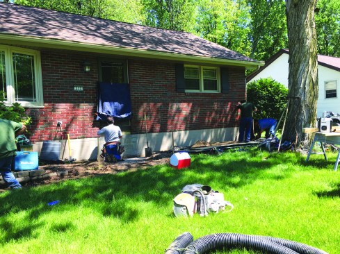 After the existing precast concrete stairway was removed, the author prepped the framing under the entry door to receive the new ledger.