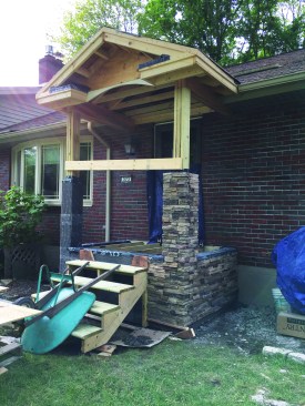 Part of the eaves had to be removed and pockets cut into the brick cladding to allow the headers that support the roof framing to be securely connected to the house’s double top plate with inset joist hangers and lag bolts.