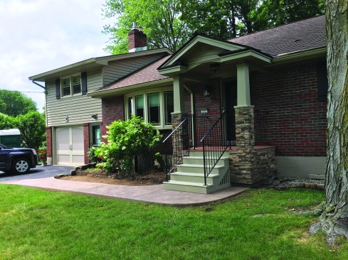 Along with a new poured concrete walkway and slip-resistant stair treads, the covered porch creates a safe and welcoming entry to the home.