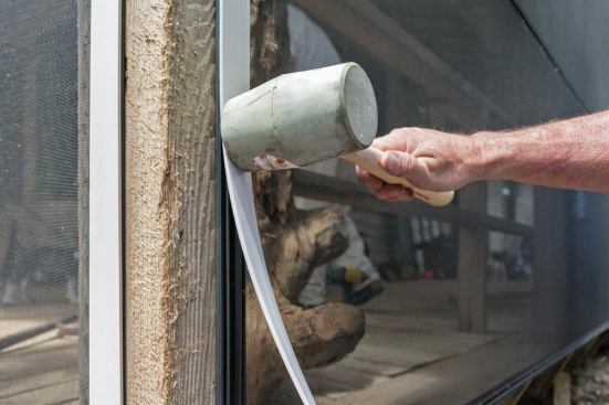 After the screen has been attached to the Screen Tight  base with splines, a removable vinyl cap is snapped onto the base, which evenly tightens the screening.