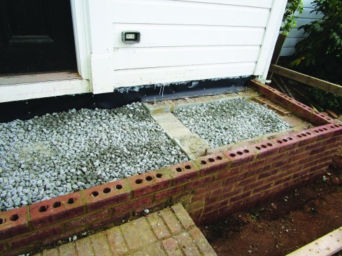Then he laid up a pair of block walls faced with brick on either side of the masonry stoop.