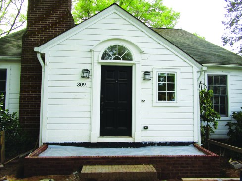 Before pouring a new slab flush with the brickwork, he installed vinyl flashing to serve as a vapor barrier between the concrete and the mudsill and primed the cut edges of the siding and trim.