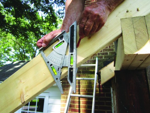 The author used a Pivot Square (chhanson.com) to accurately measure the slope of the existing roof, placing it against a level to find the 8-in-12 pitch.