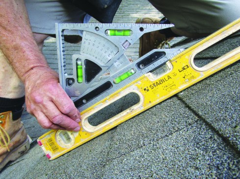 Then he set the tool to that pitch and used it to lay out the birdsmouths and plumb cuts on the rafters.