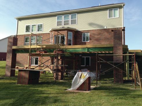 This deck is conventionally framed with 6x6 wood posts. The masonry columns are laid up around each post and tied to it with galvanized brick ties. 