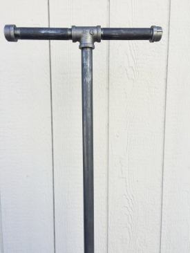 A T-fitting and a pair of 6-inch-long pipes with end fittings serve as a handle. 