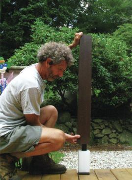 Structural metal posts have height-adjustable plastic mounting spacers at the top and bottom that are sized to fit standard 4x4 post sleeves. Rails and rail brackets can be fastened through the post sleeves into the spacers.