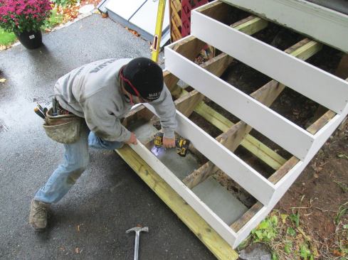 After the new concrete landing pad was poured, the middle stringers were trimmed to fit and attached to the pad with angle brackets.