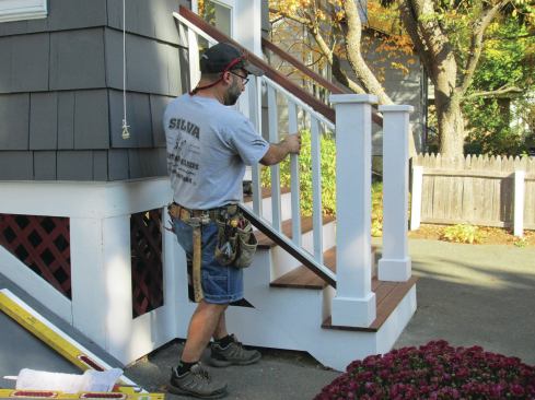 The railings have painted fir balusters, 1/2-inch by 1 1/2-inch PVC subrails, and top and bottom mahogany rails that measure 1 1/2 inches thick by 2 1/4 inches wide. 