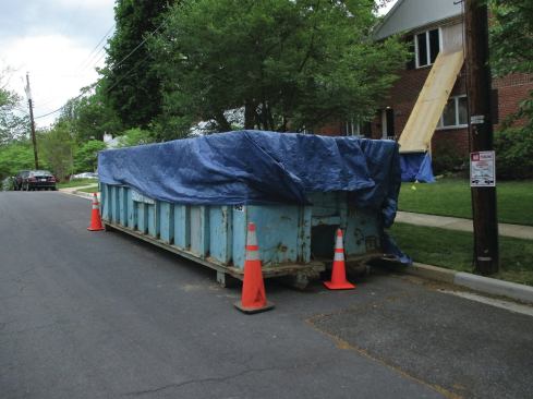 Some towns require permits to place trash bins on the street. Tarps keep trash in the bin and off the street.