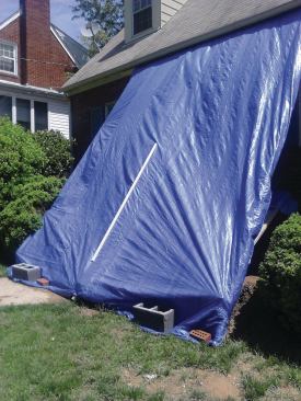 Tarp exteriors thoroughly. Blue tarps are inexpensive insurance against weather damage.