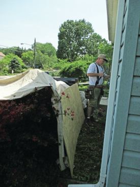 Cover shrubs and other plantings near the house during roofing or siding work.