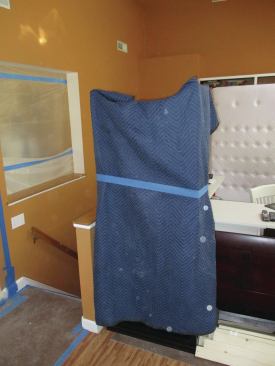 Padded movers' quilts are great for protecting appliances and large furniture. Cover the quilts with plastic sheets.