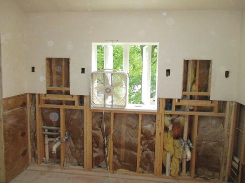 Box fans propped in windows and doors exhaust a lot of dust.