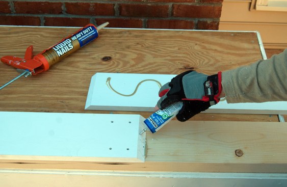 After locking the first length of trim in place with two pairs of countersunk trim screws, the author applies PVC adhesive to one face of the lap joint, which he cuts at a 45-degree bevel.