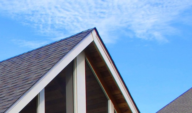 The chevron-shaped piece of decorative trim at the peak of this porch roof conceals the joint between the two pieces of PVC fascia trim, which will open and close with changes in temperature.