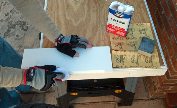 After sanding, wiping the cut down with acetone causes a chemical reaction in the PVC that closes up the cells and prevents the cut edge from trapping dirt.