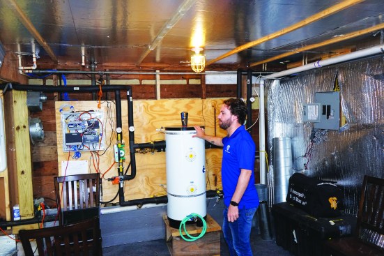 In a lower-floor mechanical room (above, right), a buffer tank isolates the indoor side of the system from the outdoor side, allowing the heat pump that powers the system to run efficiently without having to directly answer calls for cooling from the occupied space.