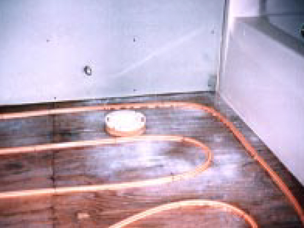 Raise toilet flanges with plywood shims to accommodate the extra thickness of the slab.