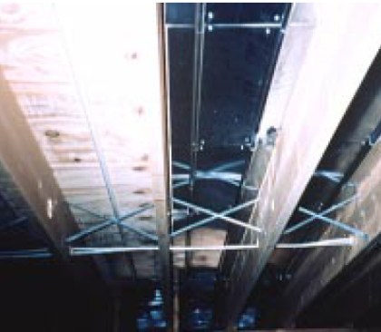 In a below-deck dry system, the aluminum plates wrap around the underside of the tubing. In new construction (top), the tubing and plates can be installed before the subfloor.