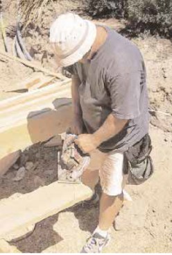 The author cuts the jacks for all four hips in a roof in sets (four hips require eight jacks of each length).