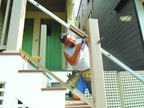He uses an offcut to mark where the handrail intersects the post ...