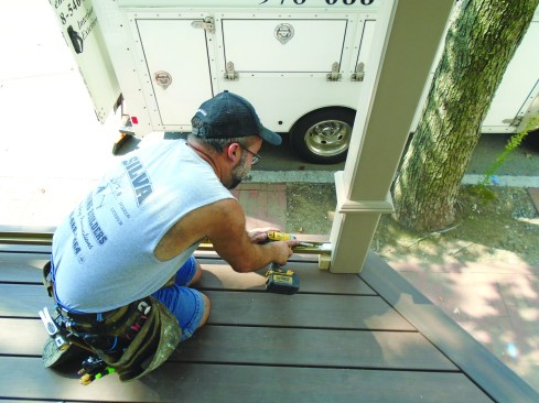 After fastening the lower beam to the posts through PVC mounting brackets that slide into the ends of the beam.