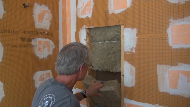 The wall between the shower and the adjoining bedroom has been soundproofed with rock wool insulation, which needs to come out.