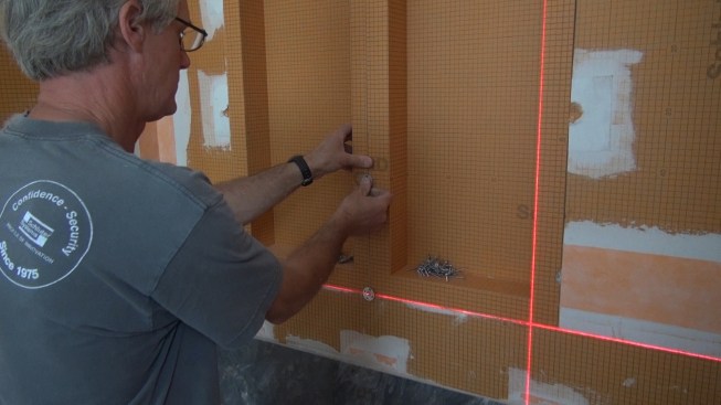 Boucher sets fastener washers into the seams where the recess boxes meet over the wall studs.