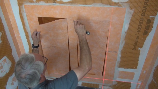 Boucher cuts out the openings with his knife (a task that is easiest before the mortar has set).