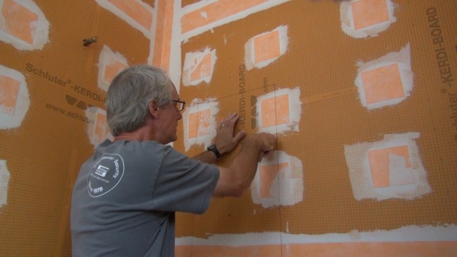 Boucher cuts out the Kerdi-Board to create an opening for the recess box.