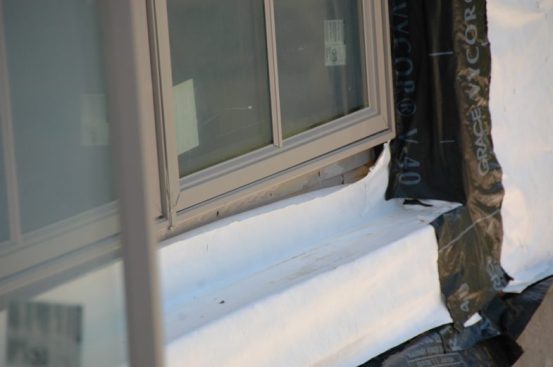 Anytime you see a sheet of “housewrap” used on a flat portion of a house you should Scream "No!" This is surely a leak waiting to happen.