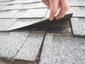 Shingle nailing. Shingles must be nailed at the ends, which did not happen in the roof pictured.