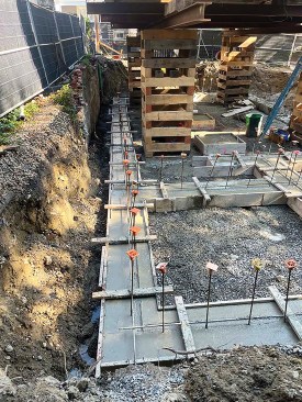 Footing pour is done with re-bar embedded for foundation walls. 
