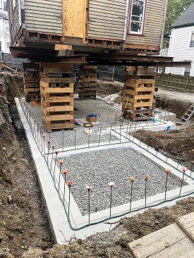 Once the footing had been poured, the site work contractor placed the subslab stone level to the tops of the footing before the foundation walls were formed and poured.