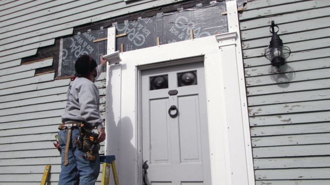 Each capital consisted of five pieces, which I primed and then glued and tacked together on the workbench before caulking and screwing the assembly in place.