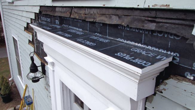 I topped the cornice cap with a layer of self-adhering flashing that slipped under the building paper above the door.