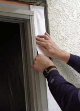To integrate the door into the weather-resistive barrier, the author adheres peel-and-stick flashing to the side jamb and then runs it over the flange and onto the building paper.