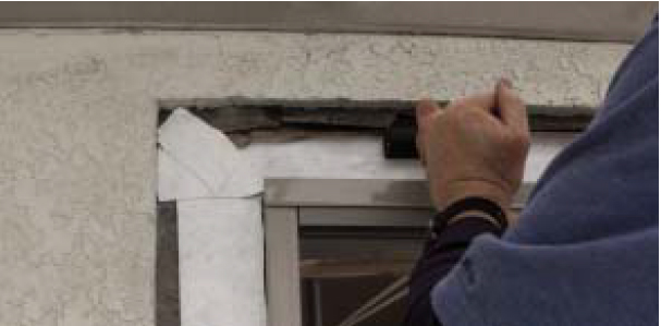 He then runs a J-Roller over the membrane to ensure good adhesion.