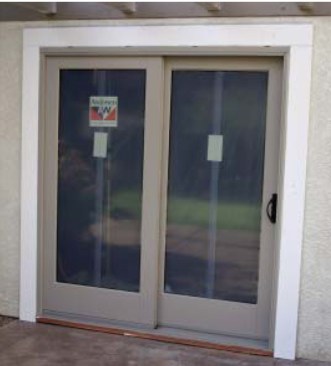 The casings are sealed to the wall with a fillet joint and — where they butt to the jamb — with backer rod and caulk. Gaps in the joint above the metal head flashing (above) will serve as weeps if water gets inside.