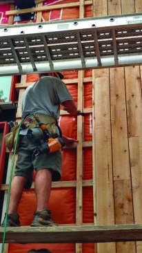 For a reverse board-and-batten cladding, the thin battens arenailed onto the wall first.