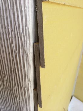 The textured surface on this housewrap, made by Tyvek, creates small vertical channels between the back of the cladding and the sheathing, allowing moisture to drain to the ground. It needs to be oriented properly when installed.